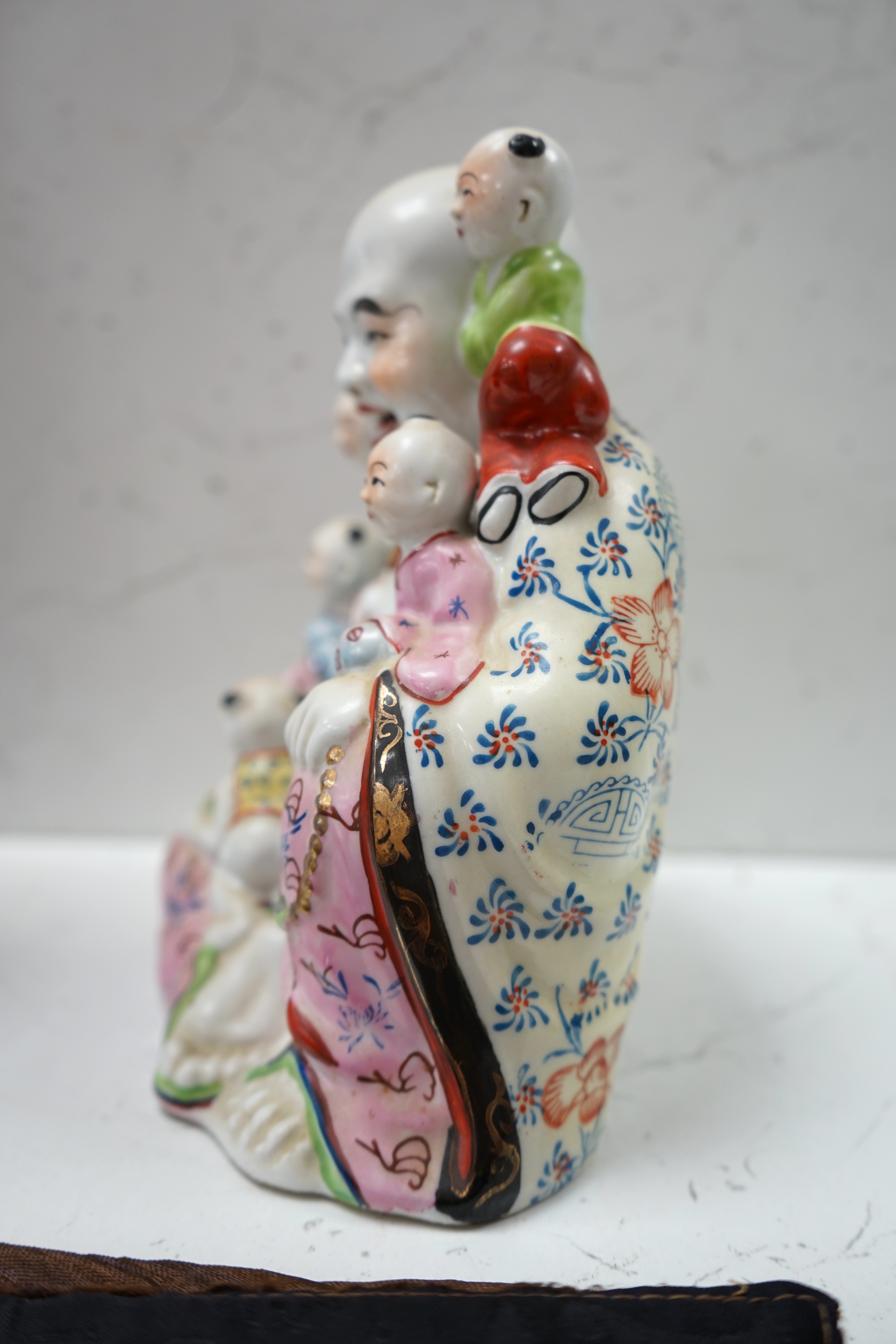 A Chinese enamelled porcelain Budai group, 20cm. Condition - good